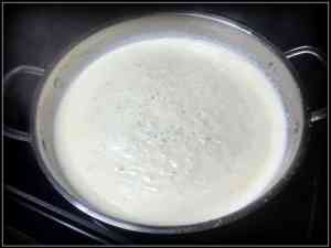 Cream sauce simmering in a large stainless steel skillet